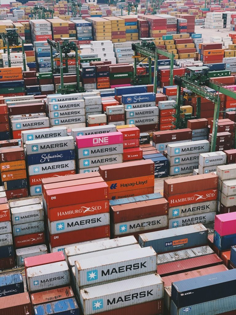 a-large-amount-of-shipping-containers-stacked-on-top-of-each-other-rlv9fxgkb40